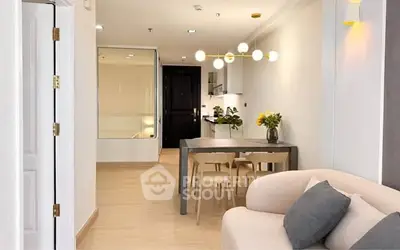 Modern open-plan living room with stylish dining area and contemporary lighting.