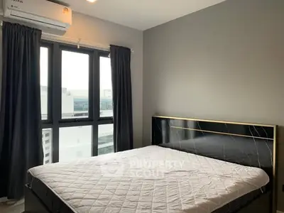 Modern bedroom with large window and stylish bed frame in urban apartment