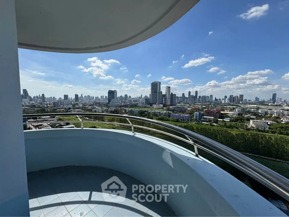 Stunning city skyline view from a spacious balcony on a sunny day.
