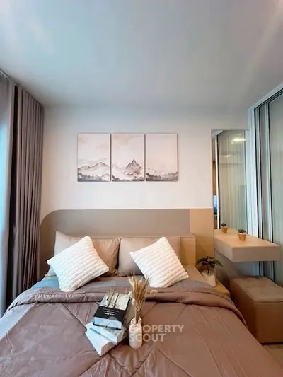 Cozy bedroom with modern decor and soft lighting, perfect for relaxation.