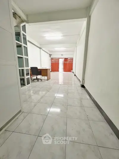 Spacious office space with tiled flooring and natural light, ideal for business setup.