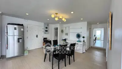 Spacious modern dining area with sleek furniture and bright lighting in a contemporary apartment.