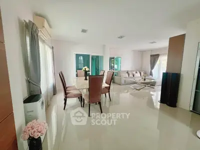 Spacious modern living room with elegant dining area and natural light