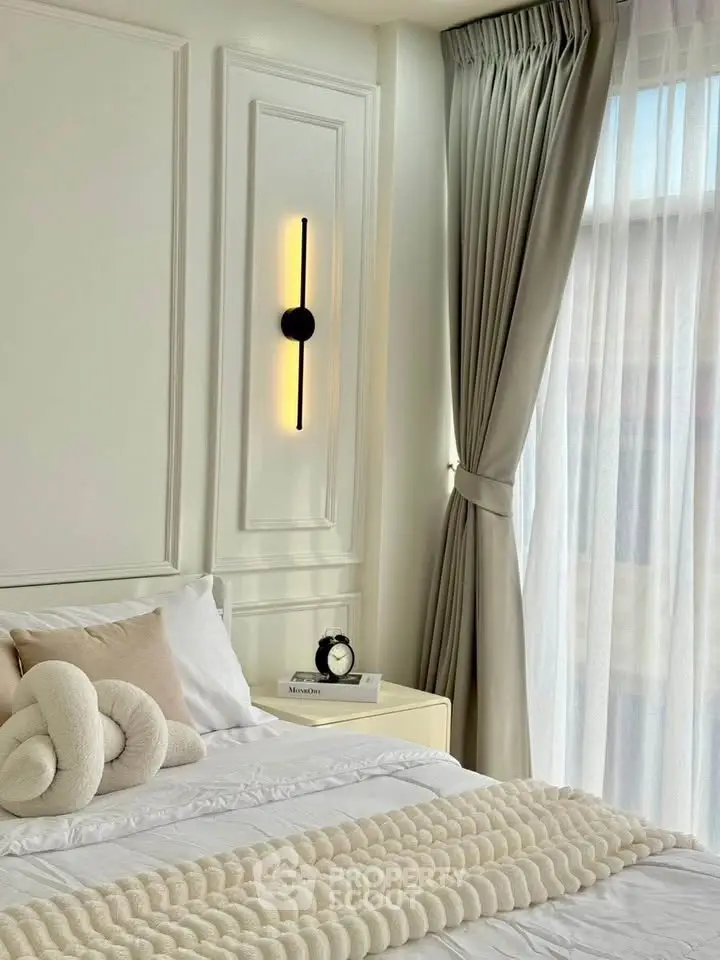 Elegant bedroom with cozy decor and natural light