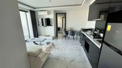 Modern living room with sleek kitchen and balcony access in a stylish apartment.