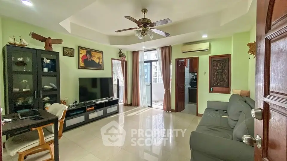 Spacious living room with modern decor and balcony access
