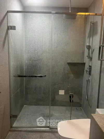 Modern bathroom with sleek glass shower enclosure and contemporary fixtures.