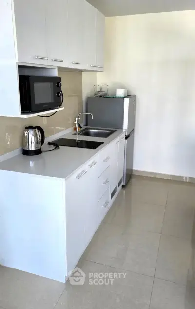 Modern kitchen with sleek white cabinets and stainless steel appliances