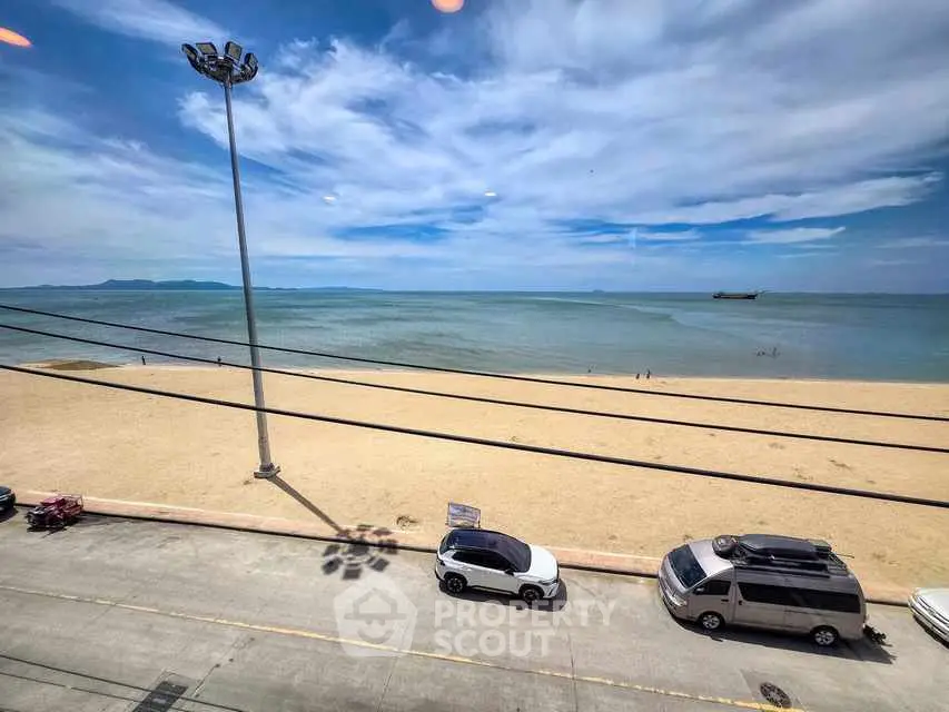 Stunning beachfront view with clear skies and sandy shores, perfect for seaside living.