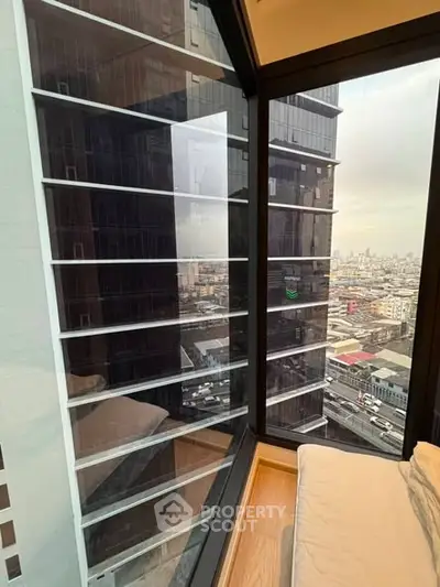 Stunning urban view from a modern high-rise apartment window, showcasing cityscape.