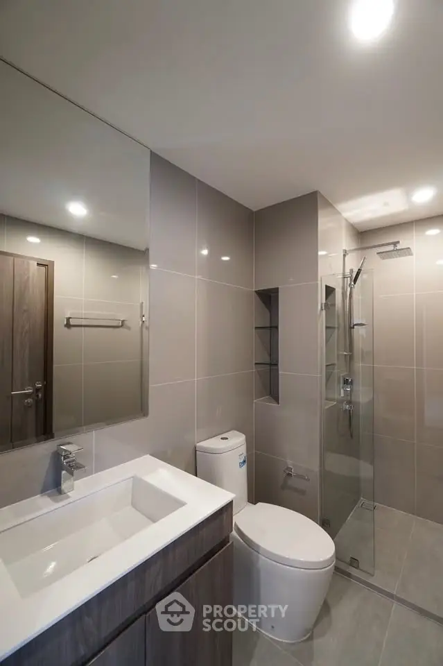 Modern bathroom with sleek fixtures and glass shower enclosure