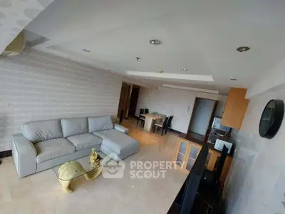 Spacious modern living room with elegant decor and ample natural light.