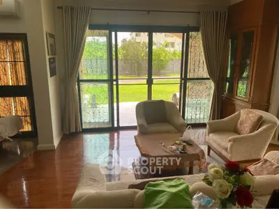 Spacious living room with garden view and elegant furnishings