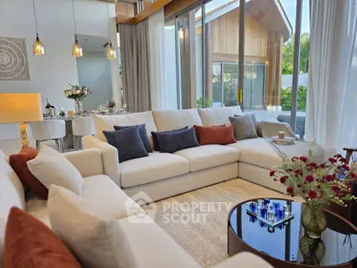 Luxurious modern living room with large sectional sofa and floor-to-ceiling windows