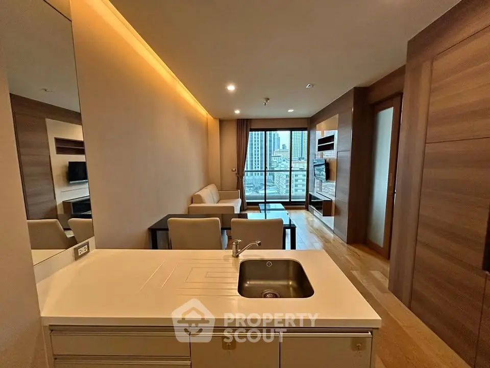 Modern living room with open kitchen and city view balcony in luxury apartment