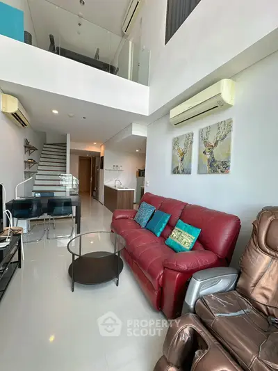 Modern living room with red leather sofa and loft-style design