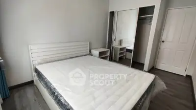 Modern bedroom with sleek design and mirrored closet doors