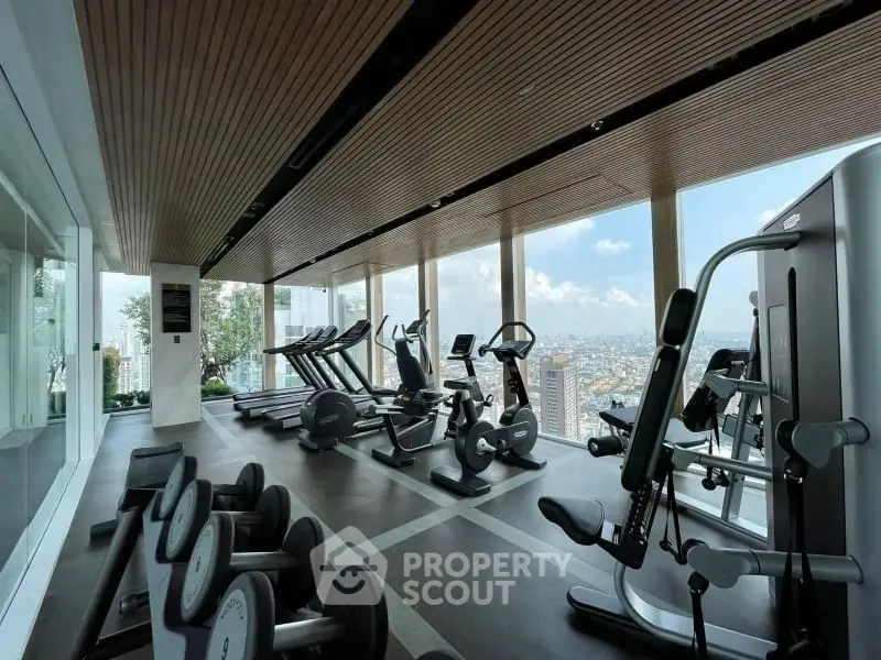 Luxurious high-rise gym with panoramic city views and modern fitness equipment.