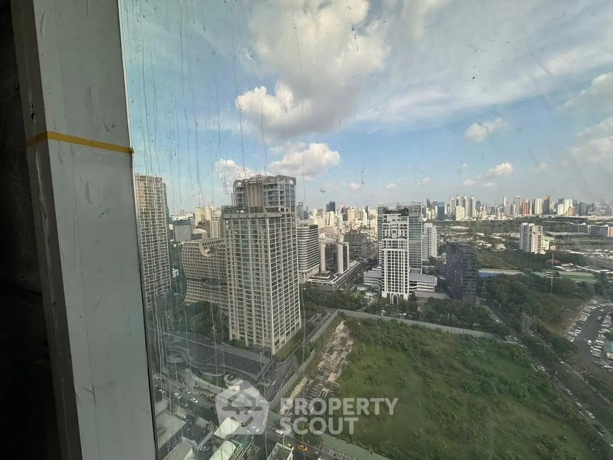 Stunning cityscape view from high-rise building window showcasing urban skyline.