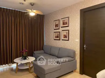 Cozy living room with stylish gray sofa and elegant decor, perfect for relaxation and entertaining.