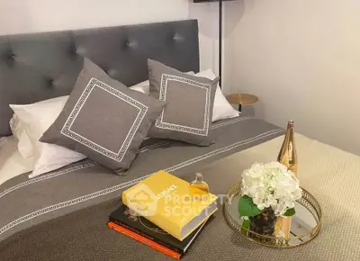 Elegant bedroom with plush bedding and stylish decor, perfect for relaxation and comfort.