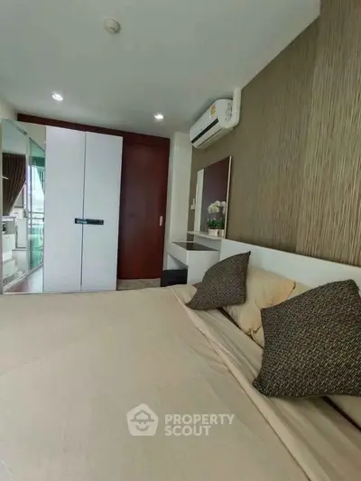 Cozy bedroom with modern decor and air conditioning in a stylish apartment.