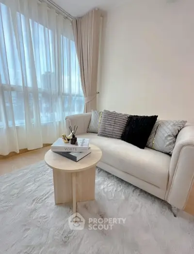 Elegant living room with cozy sofa and natural light
