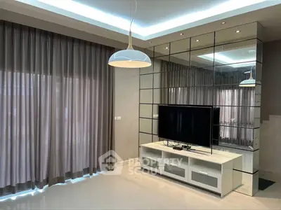 Modern living room with sleek TV setup and elegant lighting