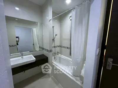 Modern bathroom with sleek design featuring a bathtub and stylish sink area.
