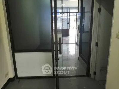 Spacious office entrance with glass doors and modern design