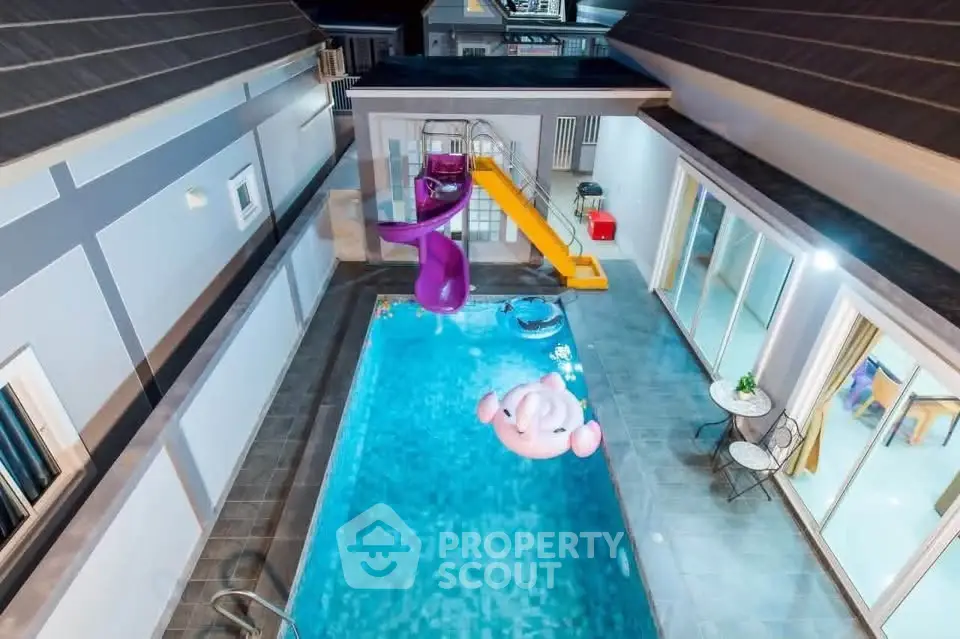 Luxurious villa with private pool and slide, perfect for family fun and relaxation.