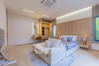 Luxurious modern bedroom with stylish decor and cozy seating area