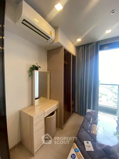 Modern bedroom with air conditioning and stylish furniture, featuring a large window with city view.