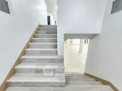 Modern staircase with sleek design in a bright, spacious interior