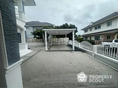 Spacious modern driveway with elegant pergola in upscale residential area.