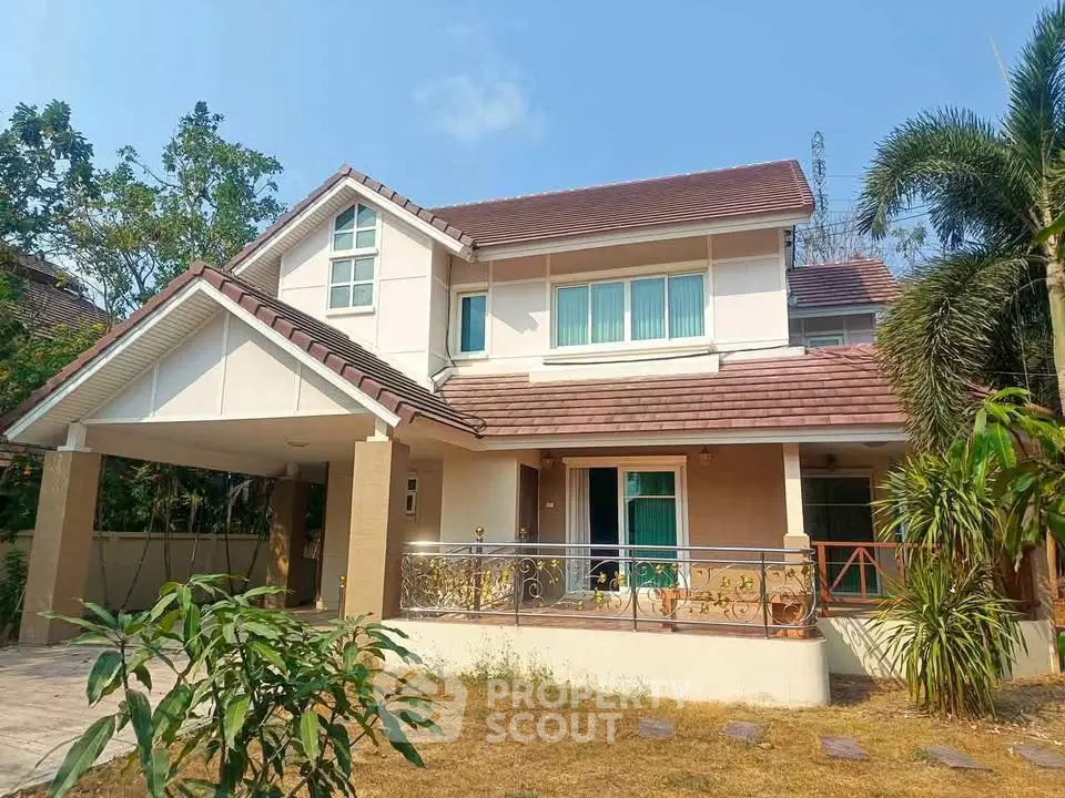 Charming two-story house with a spacious front yard and elegant balcony, perfect for family living.