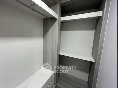 Spacious walk-in closet with modern shelving and storage solutions.