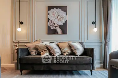 Elegant living room with plush sofa and artistic wall decor, perfect for modern interiors.