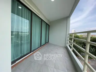 Spacious balcony with serene view in modern apartment