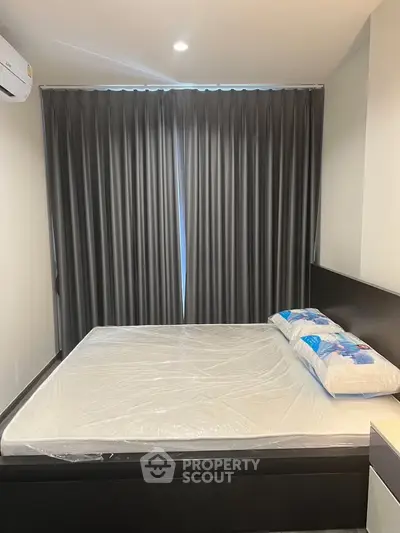 Modern bedroom with sleek design and cozy ambiance, featuring a large bed and elegant curtains.