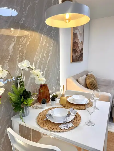 Chic dining area with elegant table setting and cozy seating in modern apartment