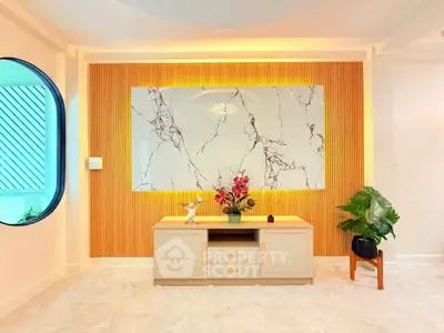 Modern living room with elegant marble accent wall and stylish decor