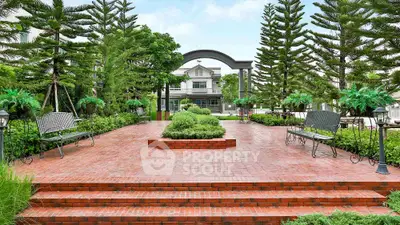 Stunning garden entrance with lush greenery and elegant brick pathway