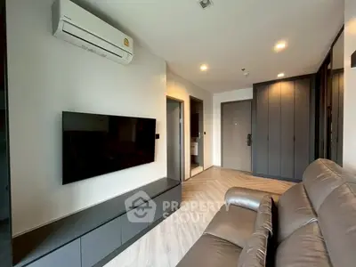 Modern living room with sleek design, featuring a wall-mounted TV and air conditioning unit.