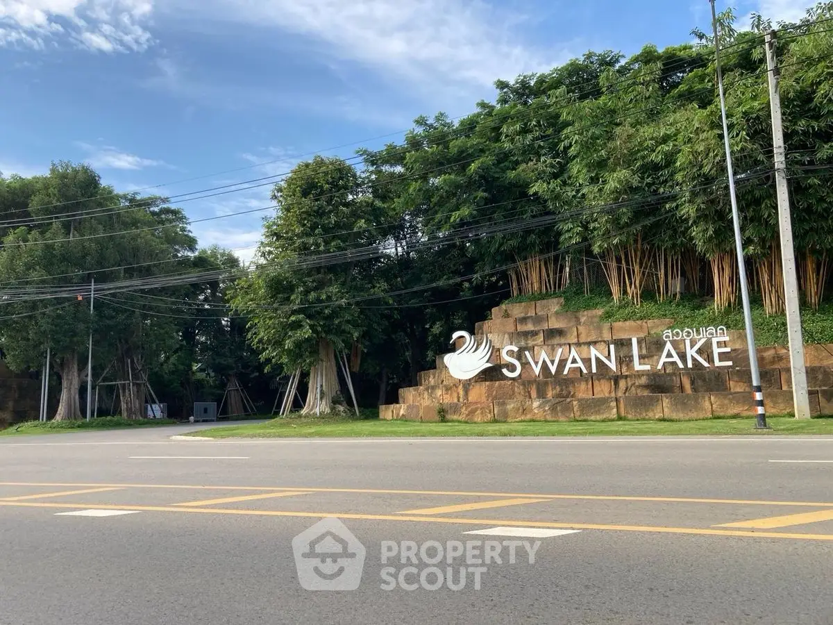 Entrance to Swan Lake with lush greenery and clear sky