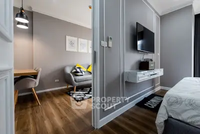 Modern apartment interior with stylish living room and cozy bedroom, featuring elegant decor and wooden flooring.