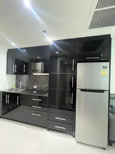 Modern kitchen with sleek black cabinets and stainless steel appliances