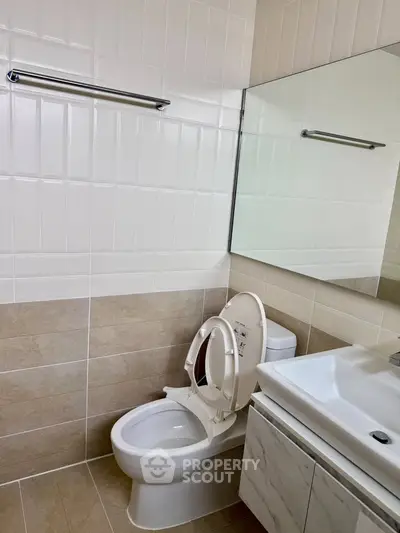 Modern bathroom with sleek fixtures and neutral tile design