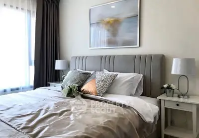Luxurious bedroom with elegant decor and plush bedding in modern apartment.
