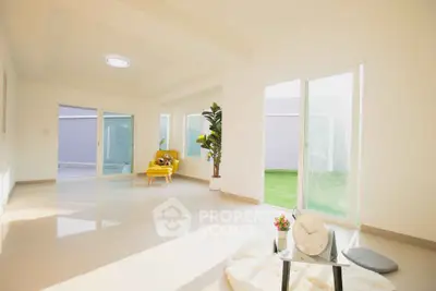 Spacious sunlit living room with modern decor and garden view